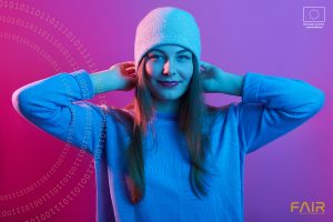 Picture of young adorable girl wearing sweater and cap, standing isolated over pink neon background, looking at camera with charming happy smile, keeping her hands behind his head, expresses happyness
