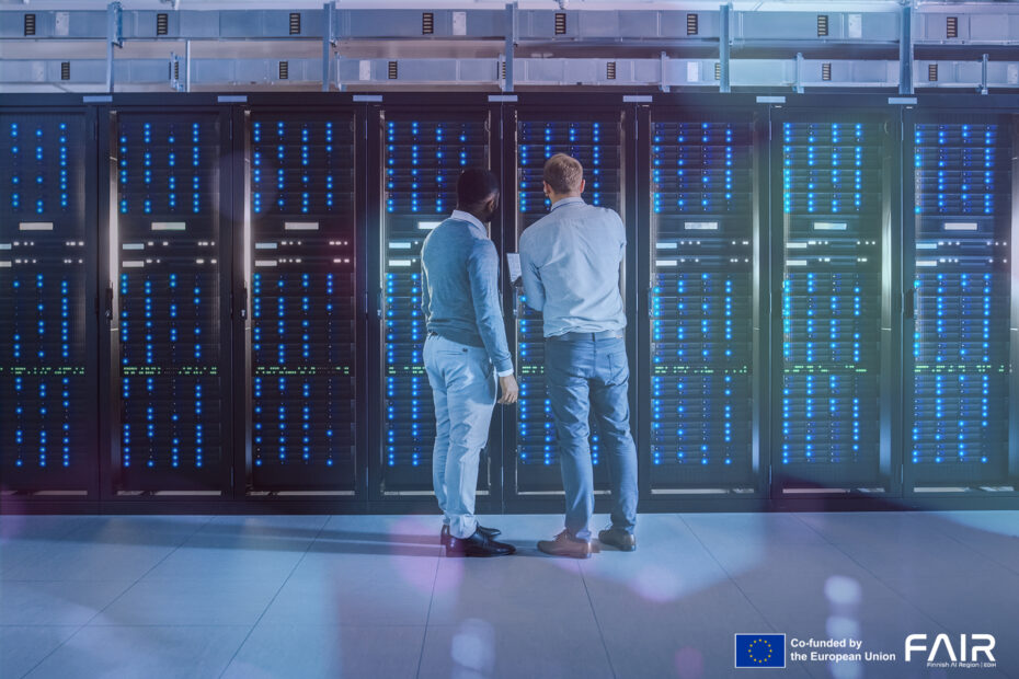 Two people standing in front of the data units