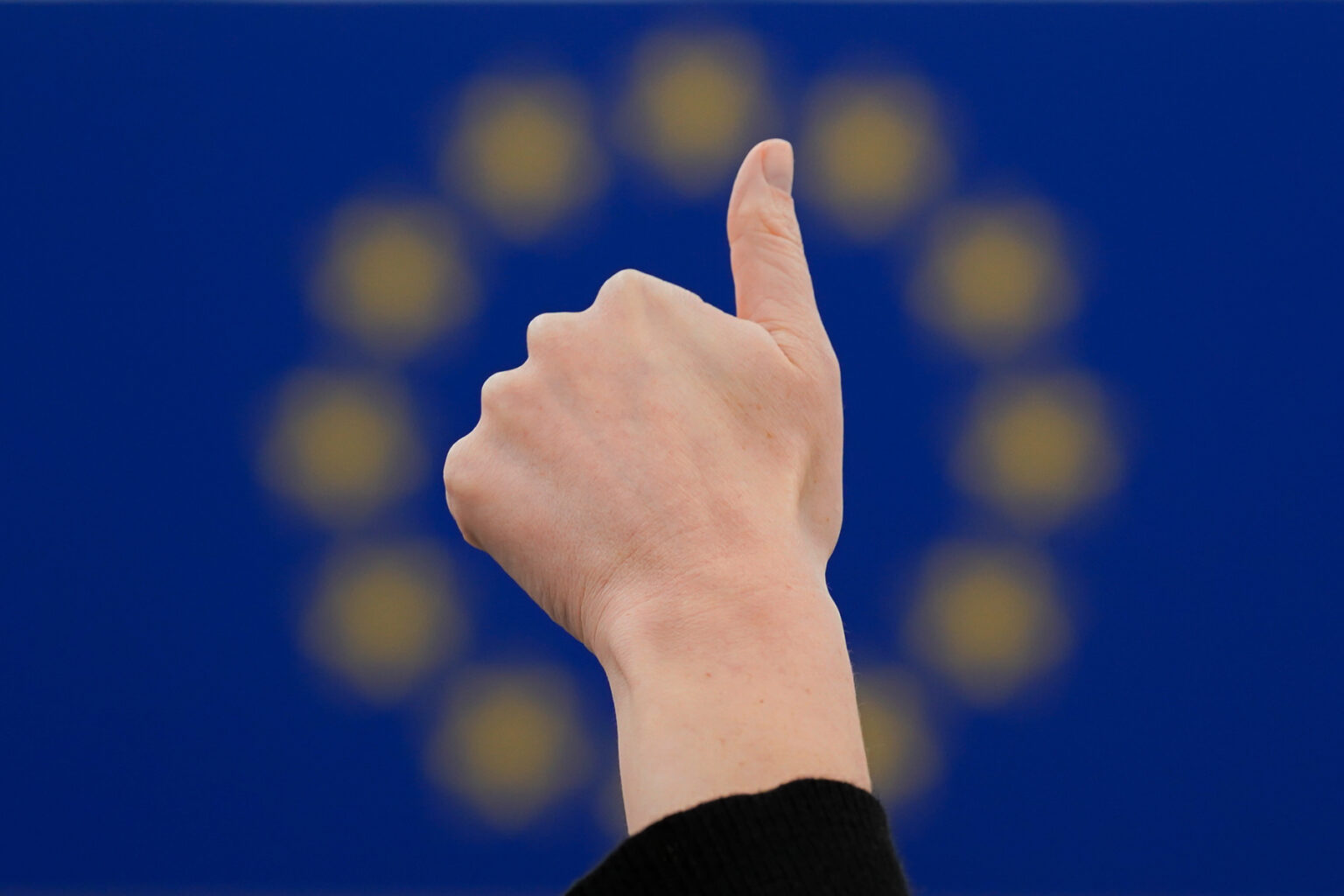 Thumb up in front of EU Flag