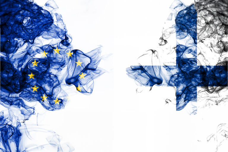 Finnish and EU flags in smoke
