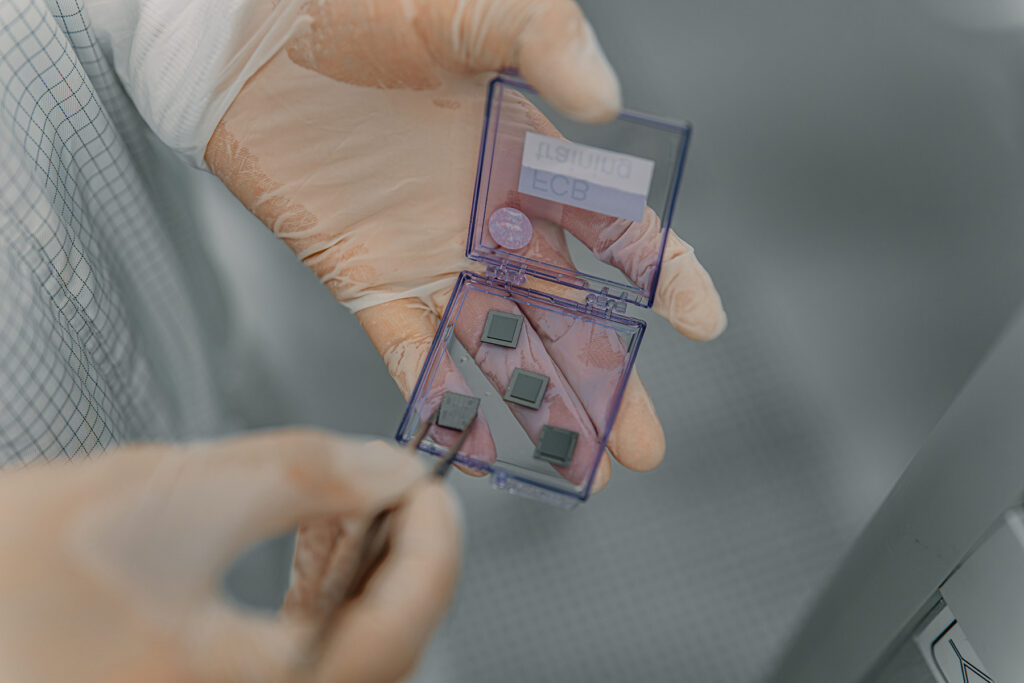 Person holding hardware from IQM's laboratory for quantum computers.