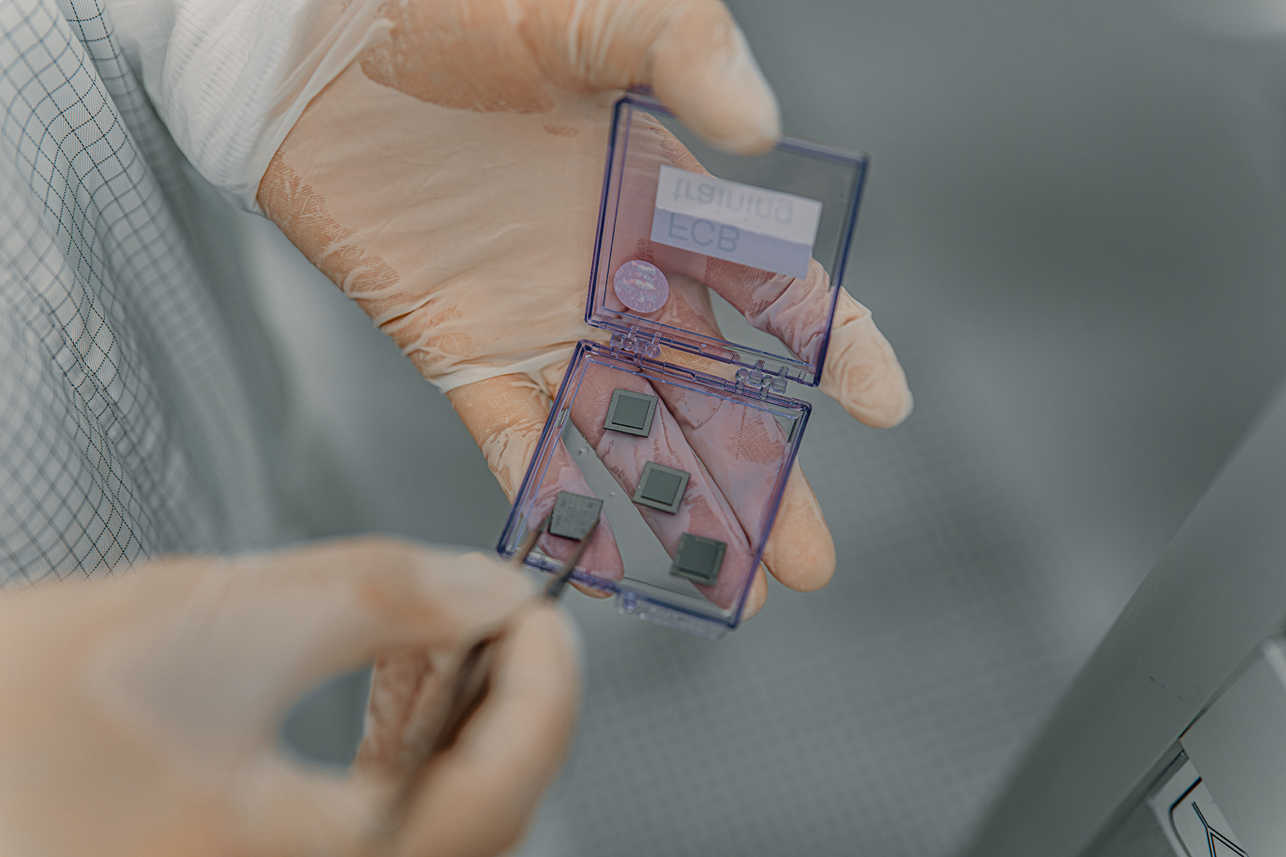Person holding hardware from IQM's laboratory for quantum computers.