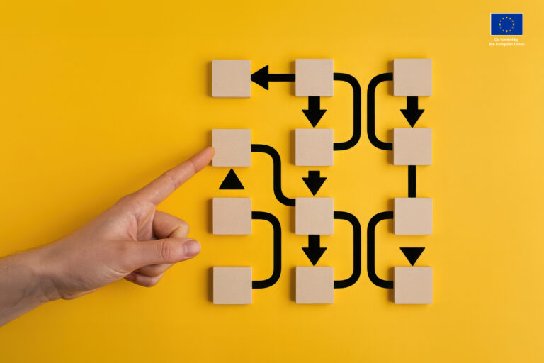 Simple picture of hand pointing to the wooden squares and the complicated system of arrows coming out of them. Representing algorithms.