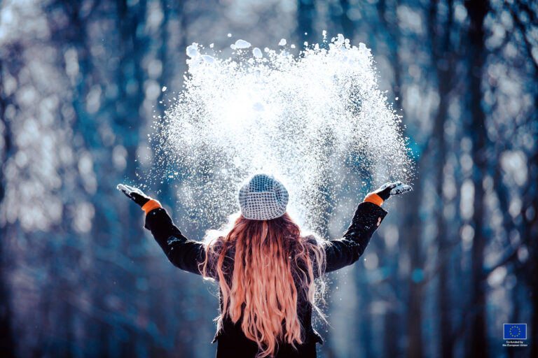 Redhead woman playing with snow in Kajaani Finland