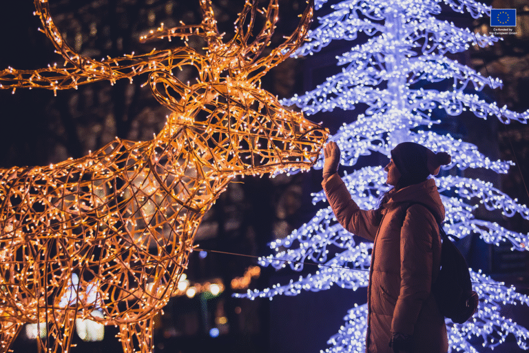 Woman touching a reindeer christmas decoration in Helsinki