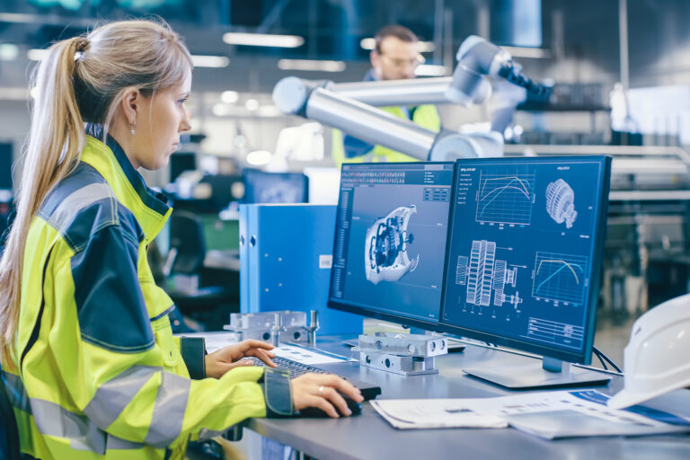 Blond haired woman, an engineer, working front of a computer