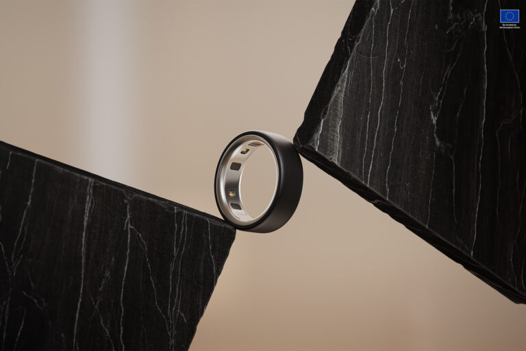 Oura ring between black marbles. Photo by Oura Health.