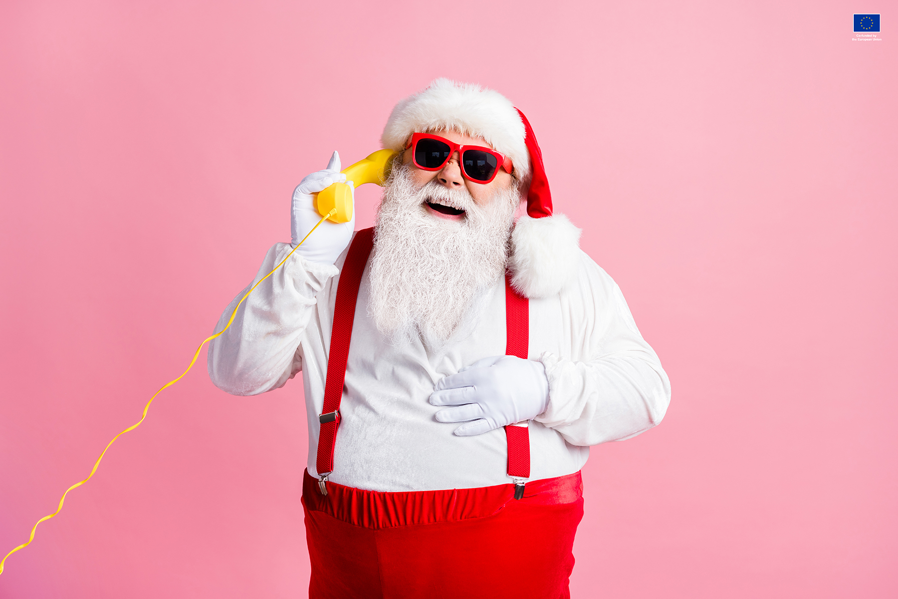 Portrait of his he nice attractive, cheerful cheery glad Santa father talking on yellow phone contact center communication laughing good joke isolated over pink pastel color background